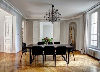 Black dining room table with chandelier
